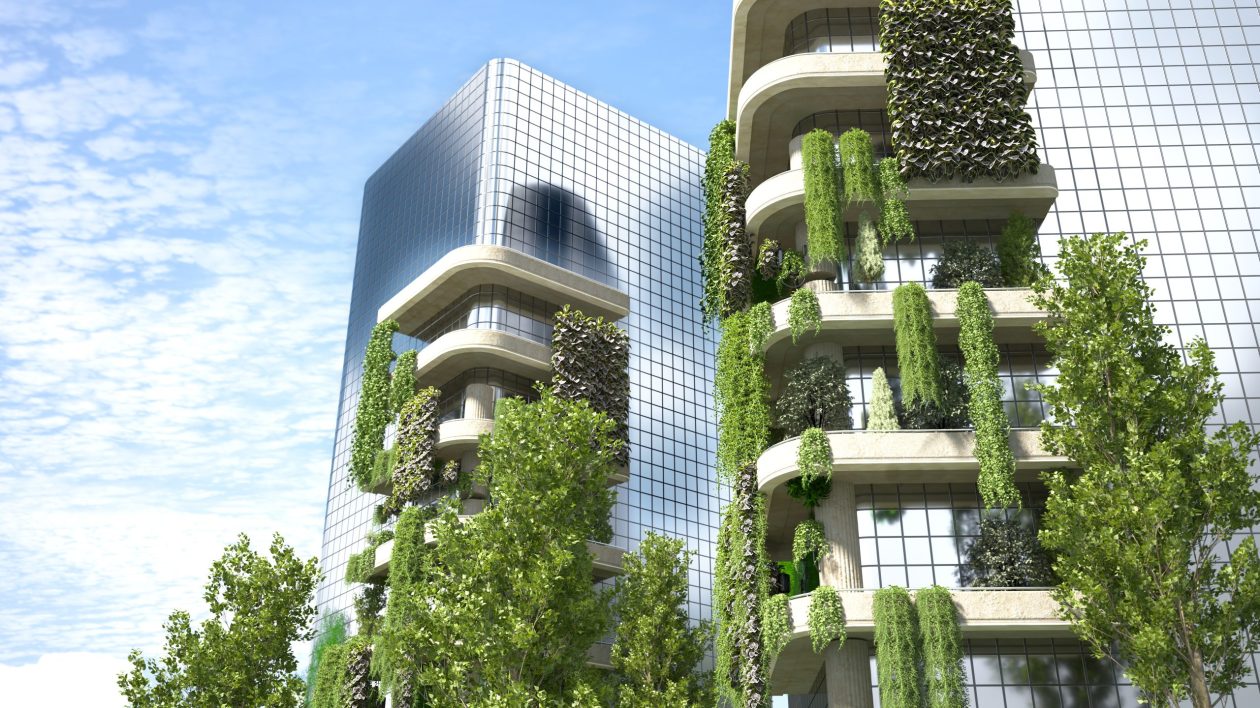 he facade of a modern building incorporates lush greenery, blending urban construction with nature. Balconies with plants wind up the structure, which reflects the sky in its glass surfaces under the bright sunlight of a clear day.