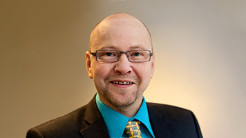 Picture of Janne Laine in front of gray background