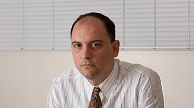 Picture of Renato Garcia in front of blinds